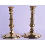 A PAIR OF 18TH CENTURY EUROPEAN BRASS CANDLESTICKS supported upon circular feet. 19 cm high.