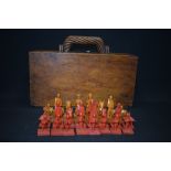 A VINTAGE ORIENTAL INSPIRED CHESS SET, contained in a box formed as a suitcase. King height 6.5 cm.