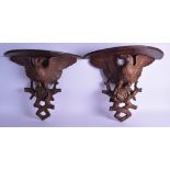 A GOOD PAIR OF LATE 19TH CENTURY BAVARIAN BLACK FOREST WALL BRACKETS modelled as eagles with their