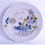 A LARGE 18TH CENTURY DELFT FAIENCE TIN GLAZED CHARGER painted with insects, flowers and hollow rock.