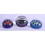 A GROUP OF THREE VINTAGE GLASS PAPER WEIGHTS possibly French, with single floral roundel and