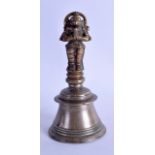 A 16TH/17TH CENTURY INDIAN BRASS BELL in the form of a standing buddhistic animal. 18 cm high.