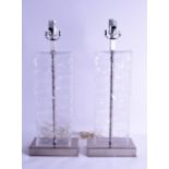 A PAIR OF CLEAR GLASS LAMPS of textured form. 54 cm high inc fittings.