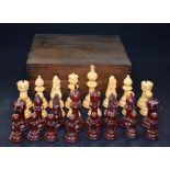 AN ANTIQUE BOXED CHESS SET, with boldly carved pieces. King height 12 cm.