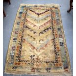 A SMALL BEIGE GROUND ANTIQUE PERSIAN RUG, decorated with foliage and motifs. 162 cm x 96 cm.