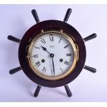 A SCHATZ BRASS BOUND MARITIME INSPIRED SHIPS CLOCK with steering surround. 32 cm wide.