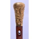 A MID 19TH CENTURY 18CT YELLOW CONTINENTAL GOLD WALKING CANE decorated in relief with figures in