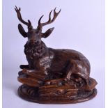 A FINE 19TH CENTURY BAVARIAN BLACK FOREST CARVED WOOD INKWELL in the form of a seated stag upon a