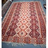 A RED GROUND ANTIQUE RUG, decorated with motifs and symbols. 263 cm x 177 cm.