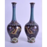 A GOOD PAIR OF LATE 19TH CENTURY CHINESE CLOISONNE VASES decorated with dragons amongst clouds. 28