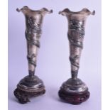 A GOOD PAIR OF 19TH CENTURY CHINESE EXPORT SILVER VASES by Luen Wo, mounted upon hardwood base,