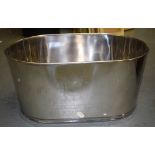 A LARGE CHROME CHAMPAGNE BATH, decorated with a crest. 30 cm x 61 cm.