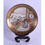 A LATE 19TH CENTURY JAPANESE MEIJI PERIOD SATSUMA DISH with fitted stand, painted with five