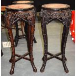 A PAIR OF 19TH CENTURY CHINESE HARDWOOD MARBLE I8NSET STANDS, with carved foliate frieze. 93 cm