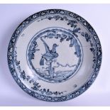 A LARGE 17TH CENTURY MING DYNASTY SWATOW WARE BLUE AND WHITE DISH painted with a stylised bird