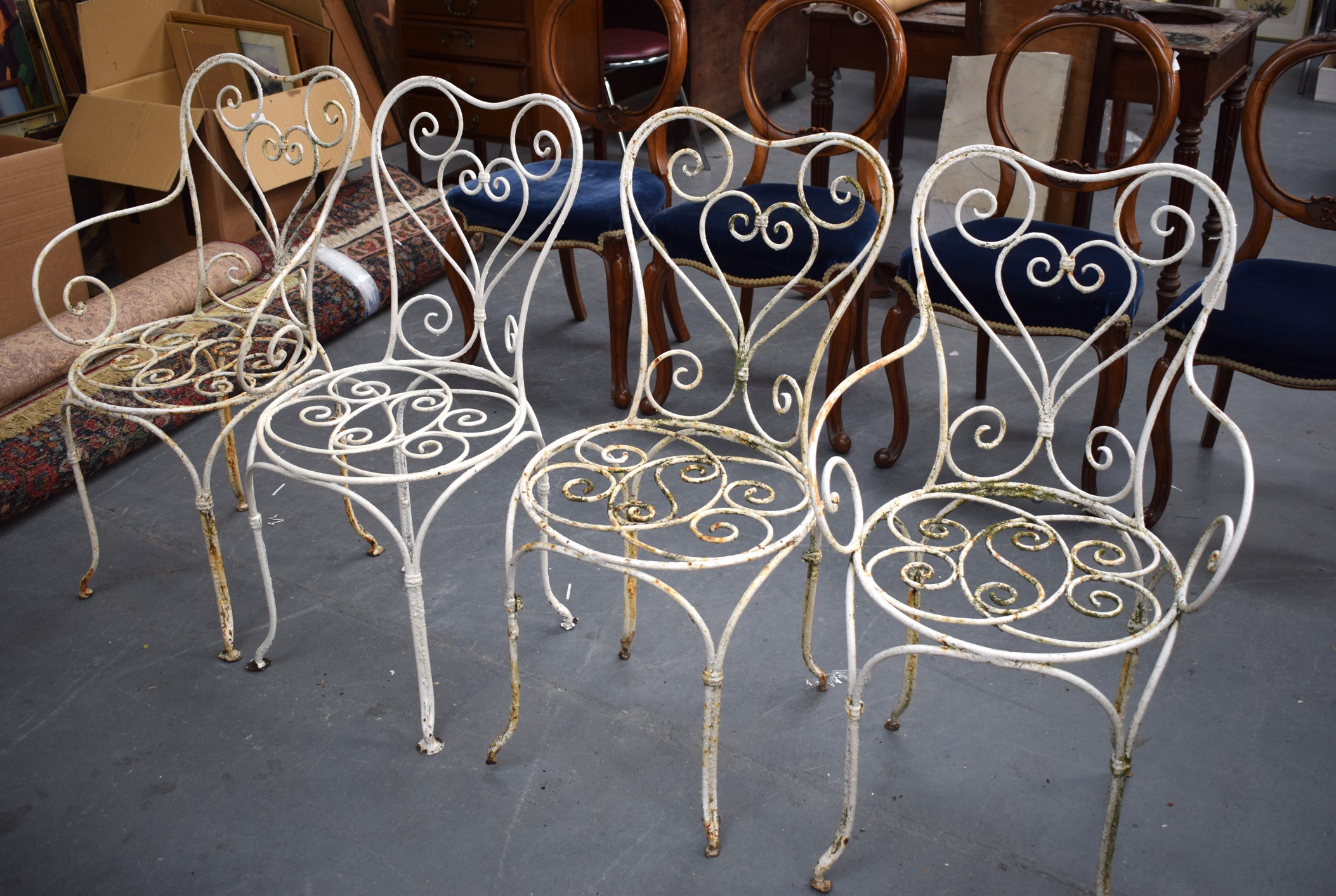 A SET OF FOUR CAST IRON CHAIRS, painted white. (4)