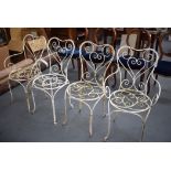 A SET OF FOUR CAST IRON CHAIRS, painted white. (4)