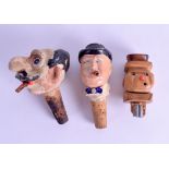 A GROUP OF THREE 1920S NOVELTY BOTTLE STOPPERS of figural form. Largest 10.25 cm long. (3)