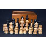 A BOXED ANTIQUE CHESS CHESS, with carved pine pieces. King height 9 cm.