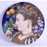 A STYLISH MINTON ART POTTERY STUDIO CIRCULAR PLAQUE by William S Coleman, depicting a female
