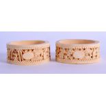 A LARGE PAIR OF MID 19TH CENTURY CHINESE CANTON CARVED IVORY RINGS decorated with foliage and