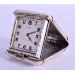 A 1920S CONTINENTAL EIGHT DAY TRAVELLING CLOCK possibly silver, with square form dial. 5 cm wide.