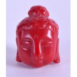 AN EARLY 20TH CENTURY CHINESE CARVED RED CORAL BUDDHA HEAD. 3 cm high.