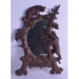 A LATE 19TH CENTURY BAVARIAN BLACK FOREST CARVED WOOD MIRROR modelled with two roaming bears amongst