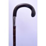 A 19TH CENTURY SILVER MOUNTED BAMBOO AND HORN WALKING CANE possibly Rhinoceros. 86 cm long.