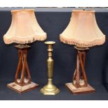 A STYLISH PAIR OF VINTAGE WOODEN LAMPS, together with a brass candlestick. (3)