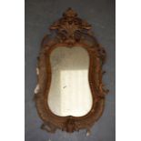 AN 18TH CENTURY CARVED GILTWOOD MIRROR, carved with shells and foliage. 74 cm x 40 cm.