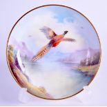 A SMALL MINTON PIN DISH in the manner of Worcester, painted with pheasants in flight over a lake.