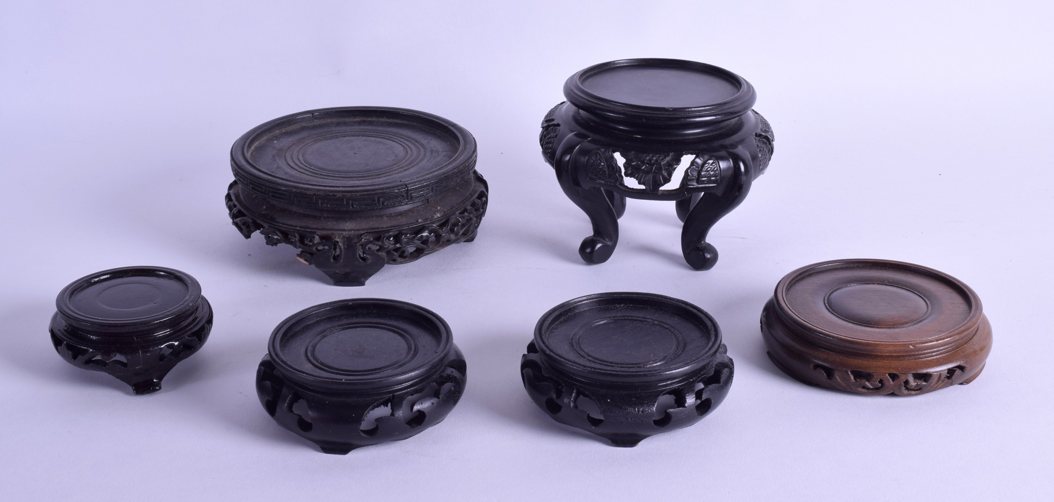 A GROUP OF SIX EARLY 20TH CENTURY CHINESE CARVED HARDWOOD STANDS. (6)