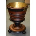 AN ANTIQUE WOODEN BUCKET, on three ball feet.42 cm.