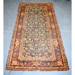 AN ANTIQUE PERSIAN RED GROUND RUG, decortaed with foliage. 182 cm x 91 cm.