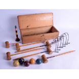 AN UNUSUAL ANTIQUE CASED TABLE CROQUET SET within a fitted box. 34 cm wide.