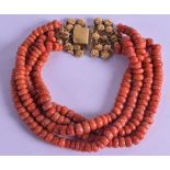 A YELLOW METAL MOUNTED CARVED RED CORAL NECKLACE. 116 grams. 50 cm long.