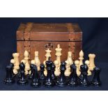 A VINTAGE BOXED CHESS SET, together with backgammon counters. King height 11 cm.