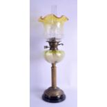 A VICTORIAN BRASS AND VASELINE GLASS OIL LAMP with flared top and circular stepped base. 65 cm