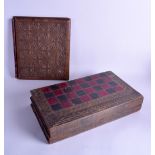 A LATE VICTORIAN/EDWARDIAN BACKGAMMON BOARD in the form of a leather book, together with a carved