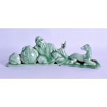 A CHINESE CELADON GLAZED POTTERY BRUSH REST depicting sage seated beside a recumbent animal. 24 cm