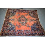 A RED GROUND PERSIAN RUG, decorated with flowers and motifs. 147 cm x 138 cm.