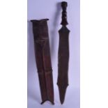 A 19TH CENTURY AFRICAN HARDWOOD HANDLED KNIFE with hide scabbard. 58 cm long.