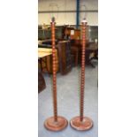 A NEAR PAIR OF CARVED MAHOGANY STANDARD LAMPS, barley twist type. 158 cm high.