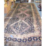 A HUGE MAROON GROUND PERSIAN RUG, decorated with motifs. 460 cm x 211 cm.