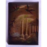 AN EARLY VICTORIAN PAPIER MACHE LACQUERED NOTE BOOK painted with birds in flight over ruins. 6.75 cm