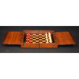 AN ANTIQUE BOXED TRAVELLING CHESS SET, with carved bone pieces. king height 3.6 cm.