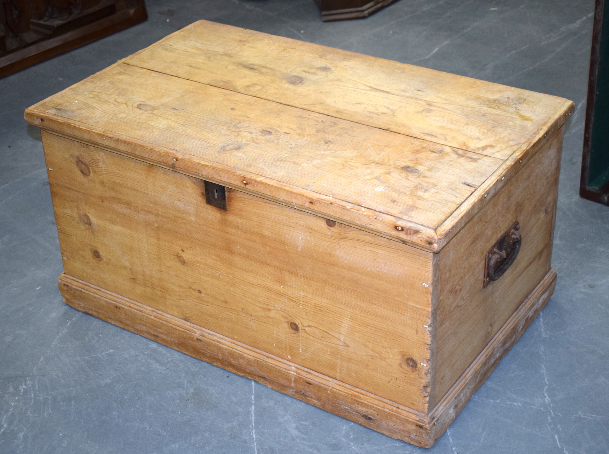 AN ANTIQUE PINE CHEST, of plain form with iron handles. 45 cm x 88 cm.