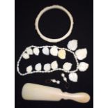 AN EARLY 20TH CENTURY CARVED IVORY BANGLE, together with necklace, earrings and shoe horn.