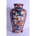 A LARGE 19TH CENTURY JAPANES MEIJI PERIOD IMARI BALUSTER VASE painted with figures within